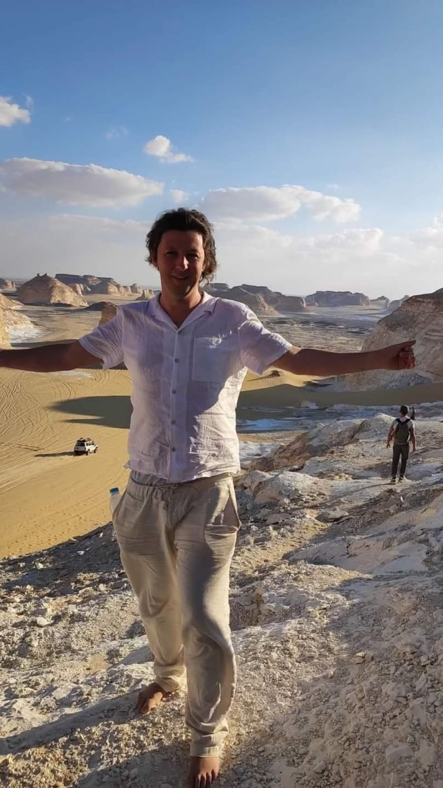 Oskar Knapik standing in a desert landscape